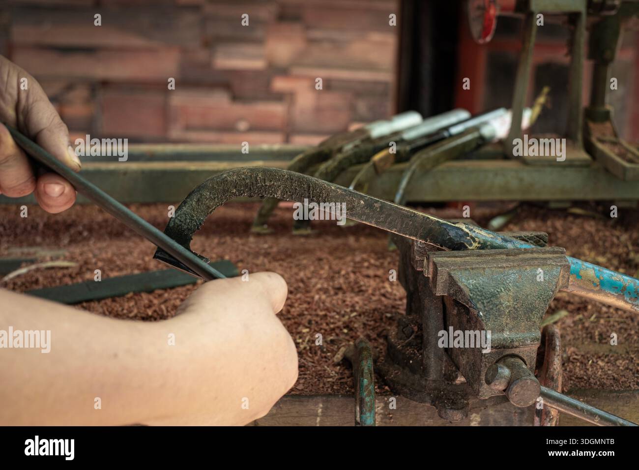 A man's hands sharpening a rubber tapping knife Stock Photo