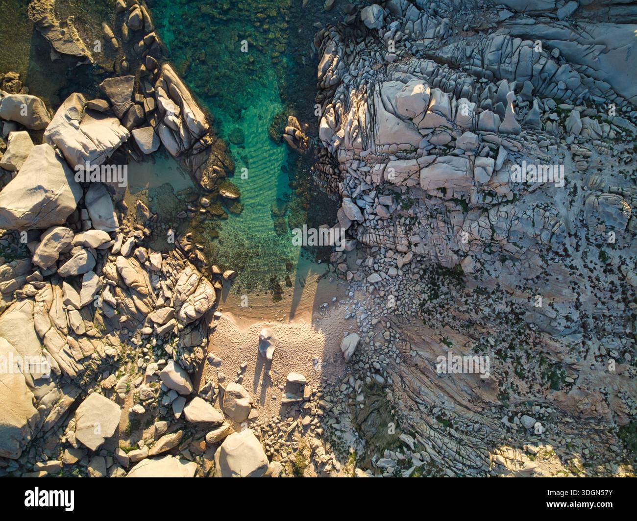 Top-down aerial view of a rugged rocky coastline with crystal clear ...