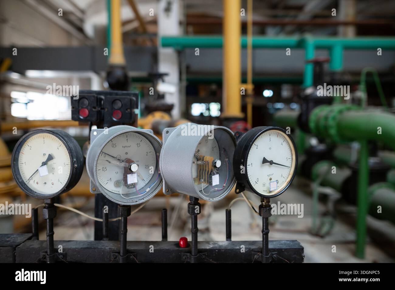 Pressure gauges at the pump station in the water preparation section of a heat exchanger circuit. The gauges are mounted on a control panel, monitorin Stock Photo