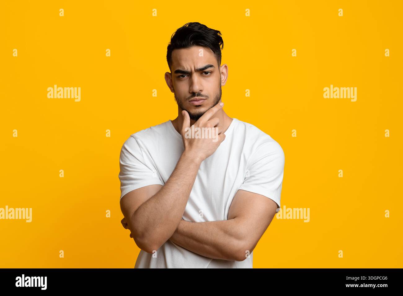 Doubting middle eastern guy looking at camera Stock Photo