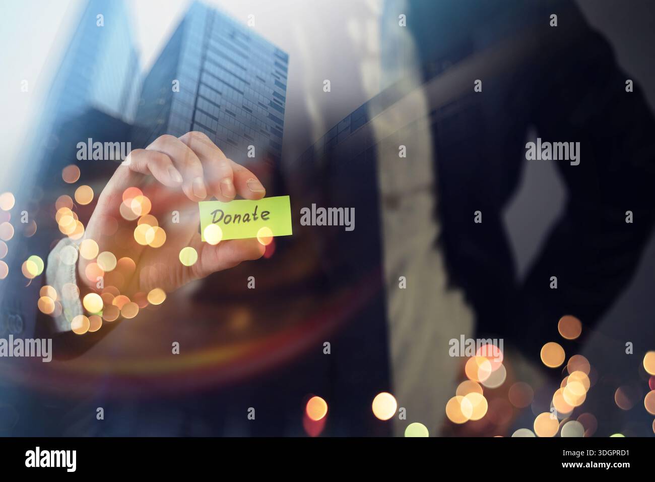 Businessman shows a wooden block with the word donate. Charitable donation in business concept. Stock Photo