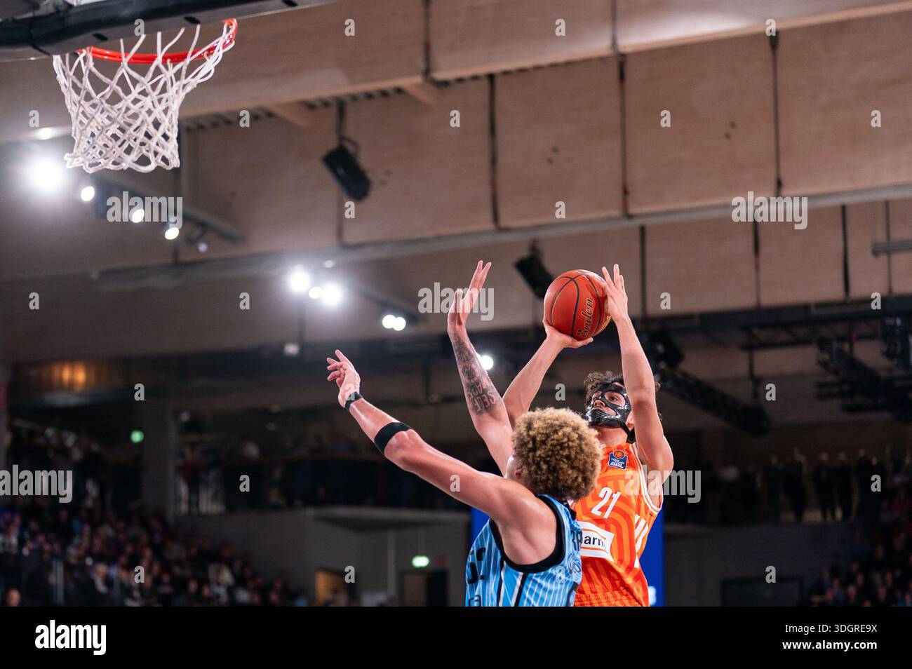 Alec Anigbata (Ratiopharm Ulm, #21) during the shot, Zacharie Perrin ...