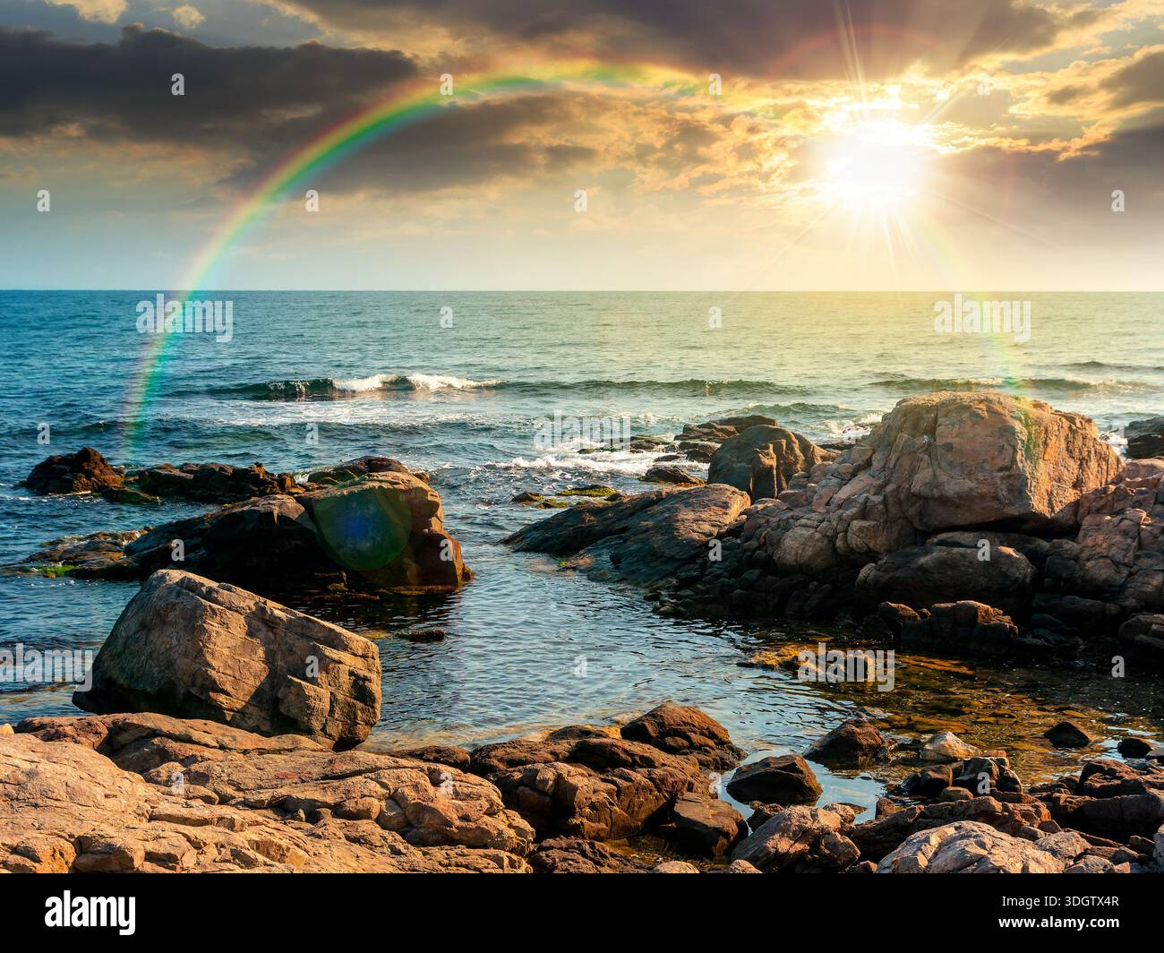 rocky shore of the sea coast under blue sky at sunset. beautiful view of coastal scene in evening light. resort scenery during vacation season in summ Stock Photo