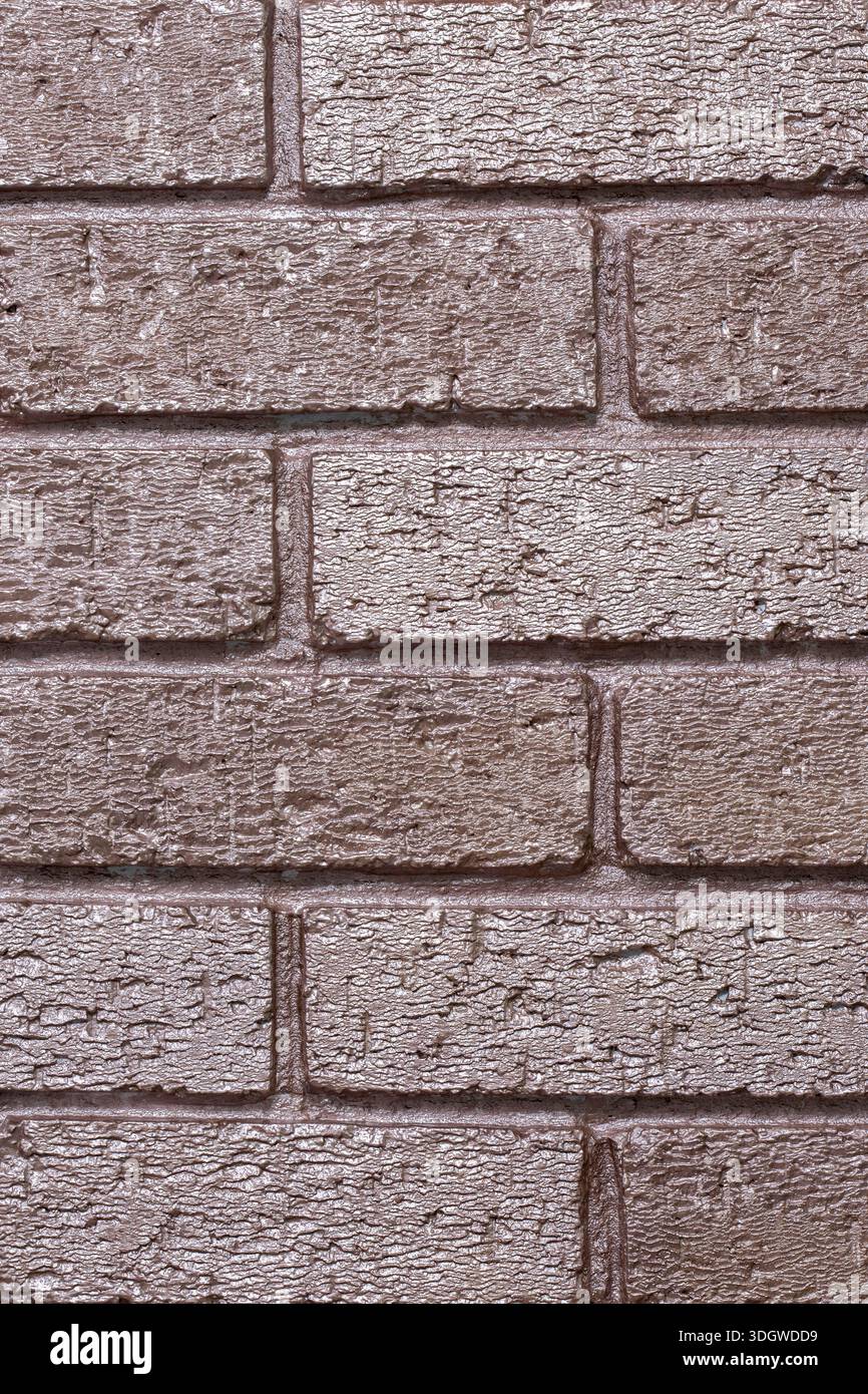 Brick wall background backdrop painted with metallic rose gold coloured paint. Interior design concept. Stock Photo