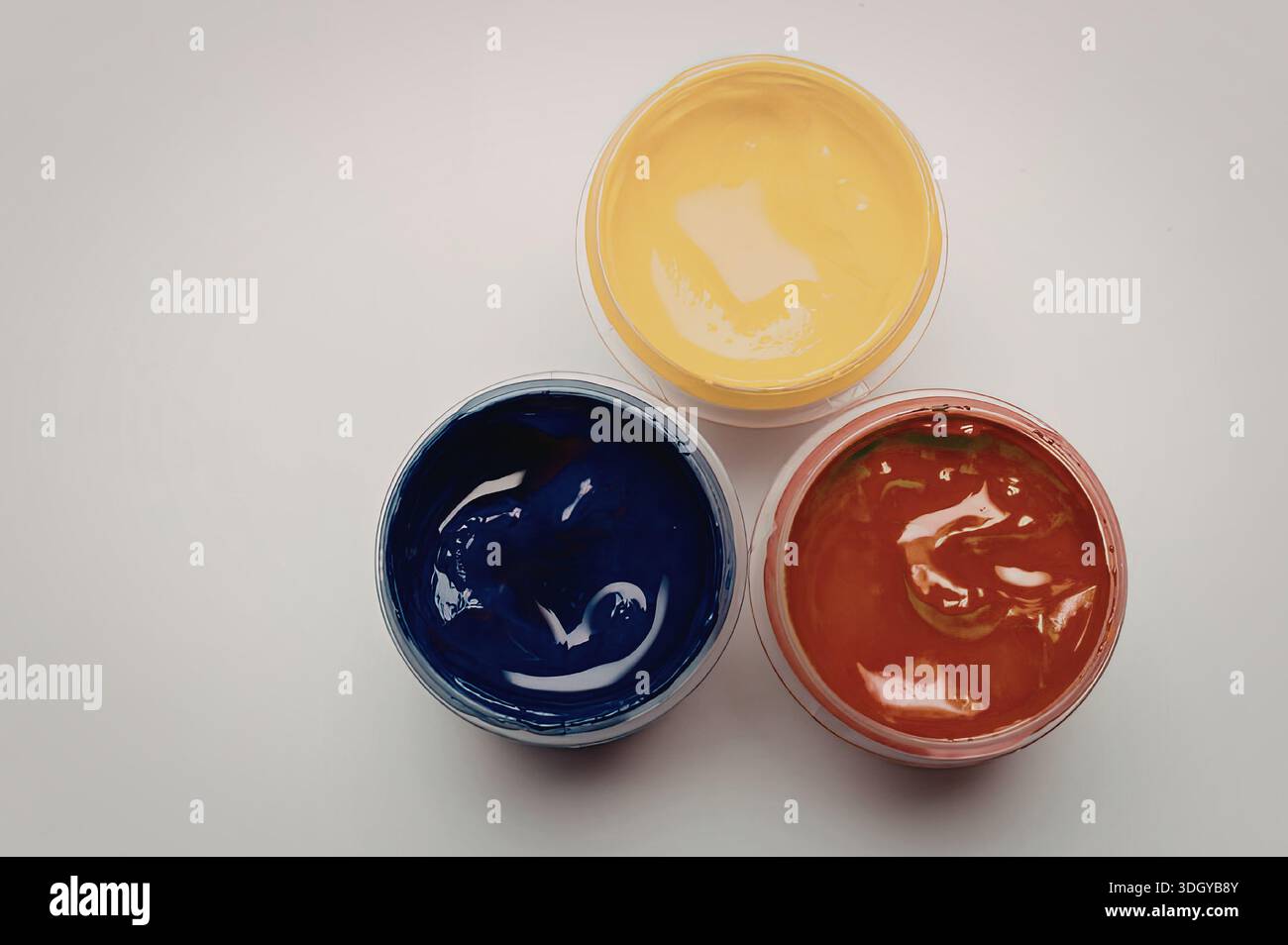 An image featuring three open paint containers, each filled with ...