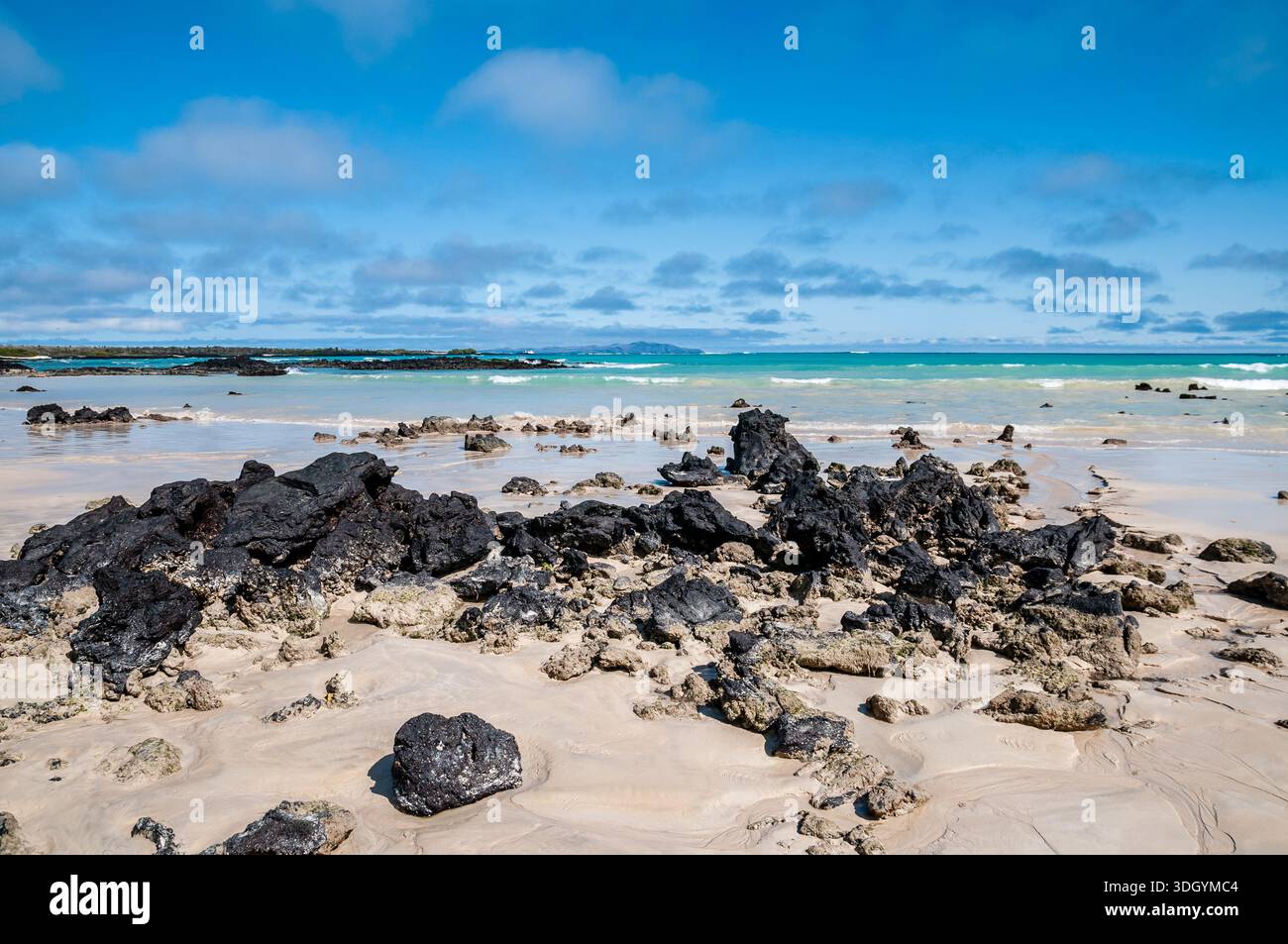 Equador Rocks Scenic view of the beach with a blue sky and some clouds, volcanic ...