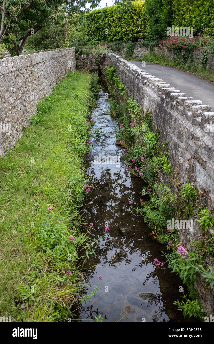 Stream running past St Illtyds Church in Llantwit Major South Wales UK Stock Photo