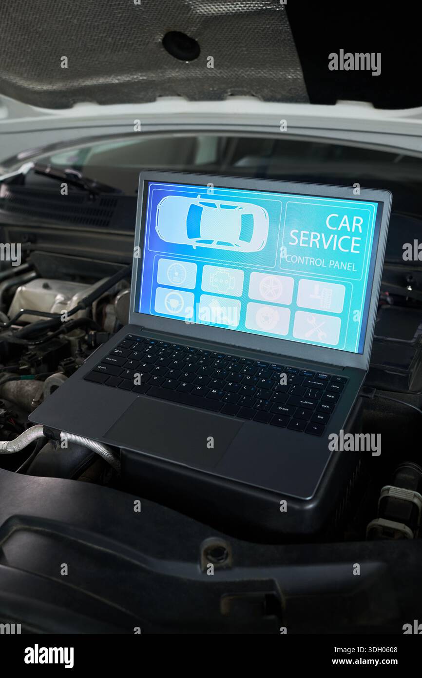 Laptop displaying digital car service control panel screen positioned ...