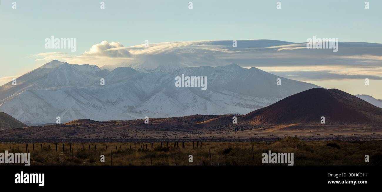 Dramatic clouds over snowy mountain landscape Stock Photo
