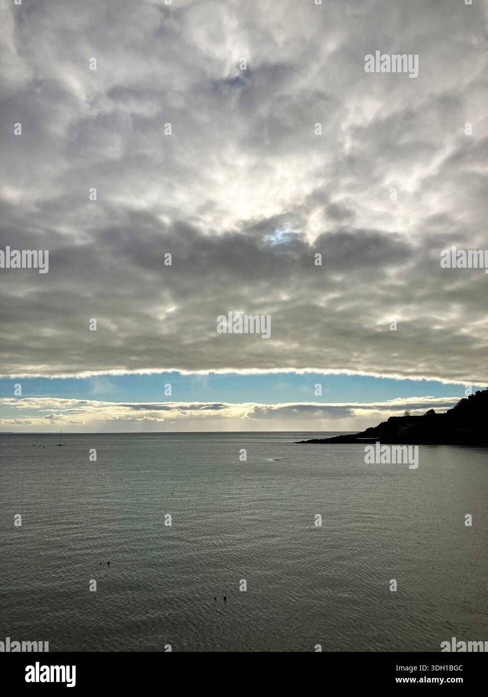 Guernsey. Saint Peter Port. Coast headland silhouette with stormy sky. Stock Photo