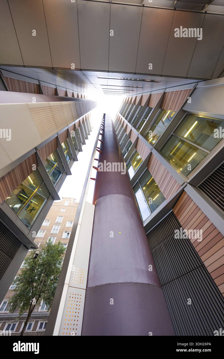 A symmetrical upward look between two modern buildings, London, England, Great Britain Stock Photo