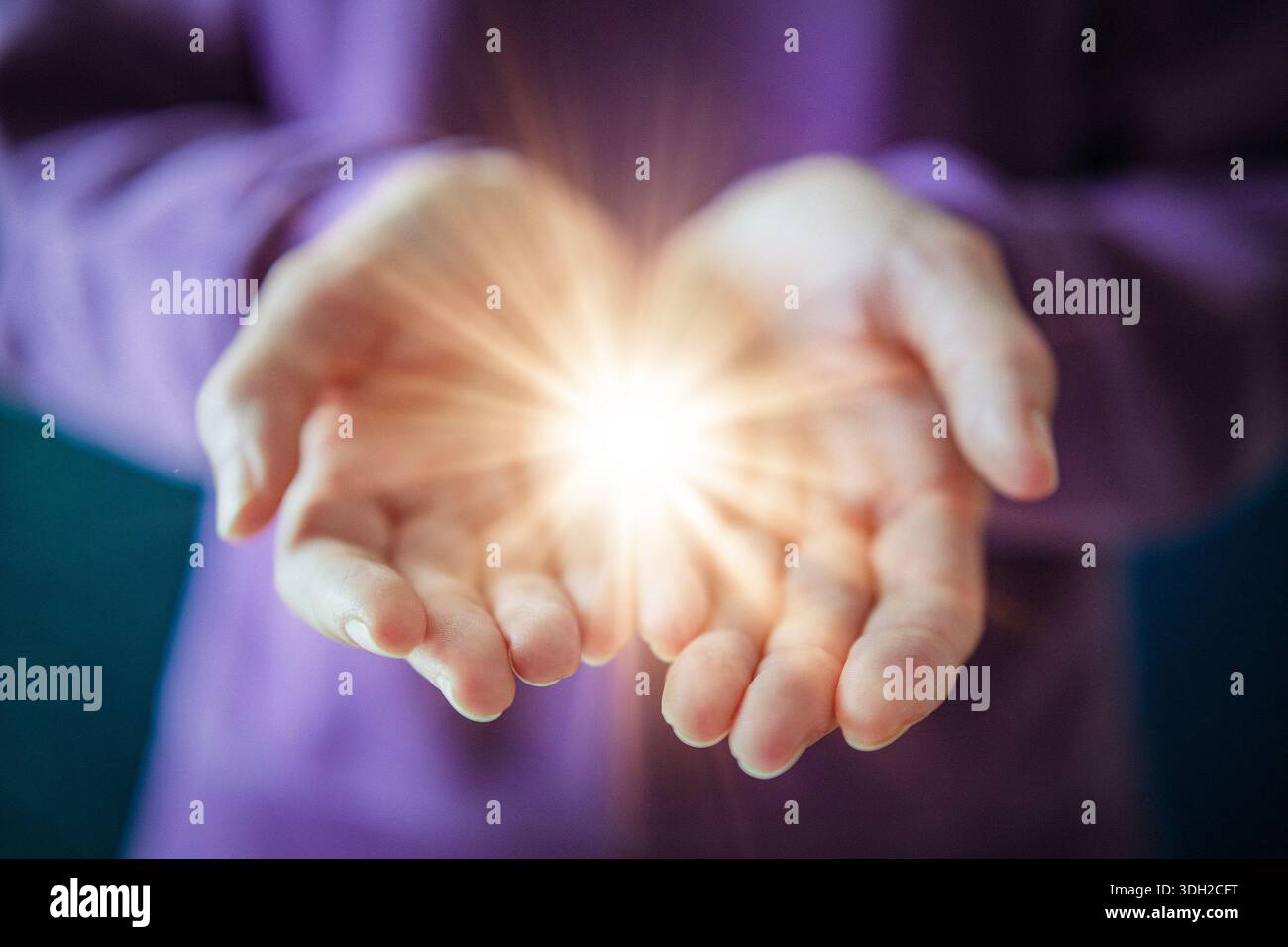 Woman Holding Glowing Light in Open Hands as Give to Gain Symbol of Empowerment and Sharing Stock Photo
