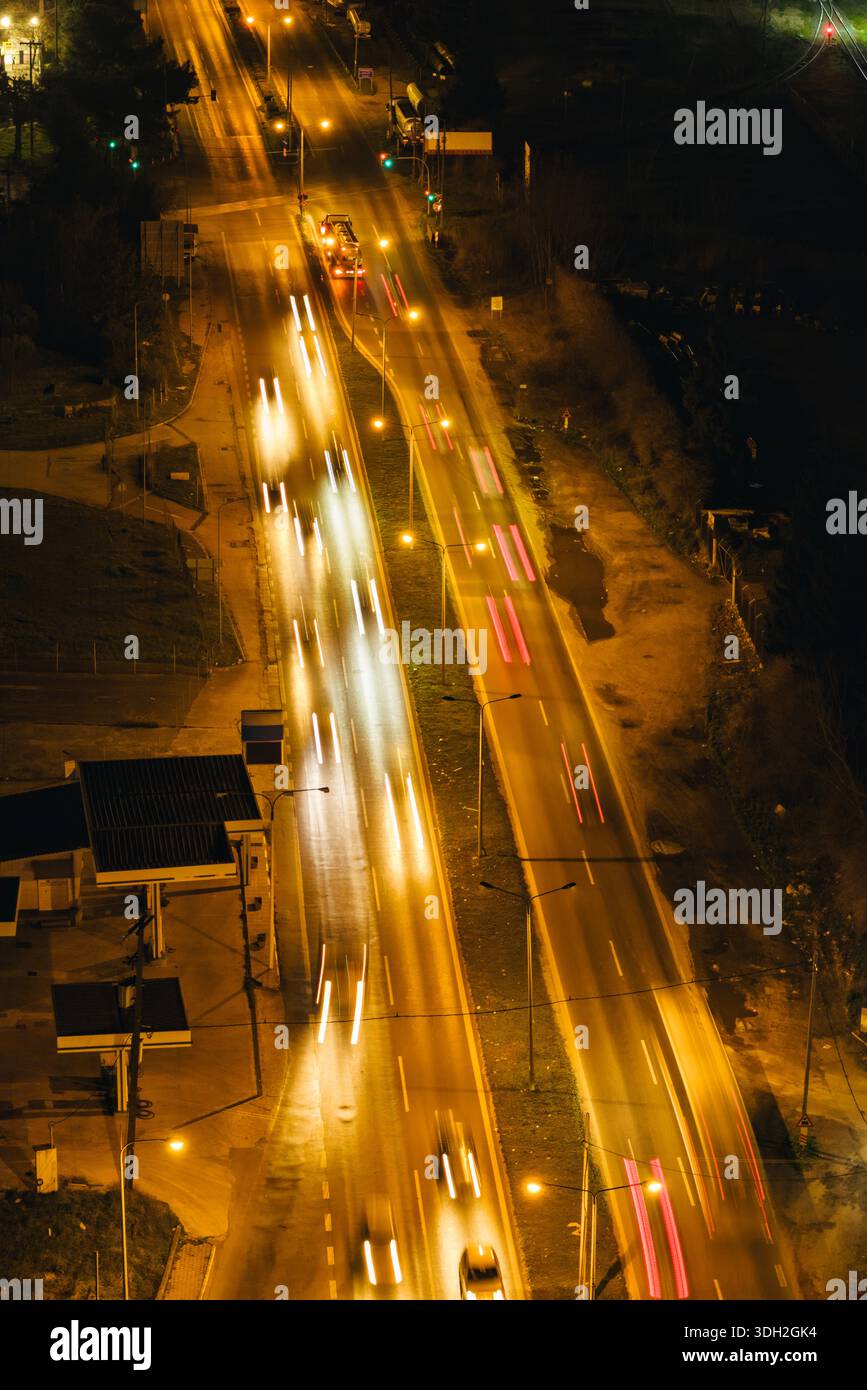 Thessaloniki, Greece — Aerial night view of a busy multilane road in the western districts, with light trails from vehicles and illuminated infrastruc Stock Photo