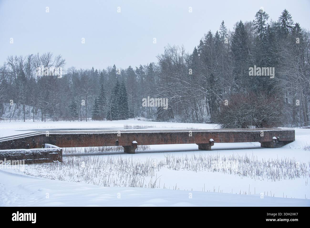Rustic Bridge Over Frozen Waterway in Estonian Winter Stock Photo - Alamy