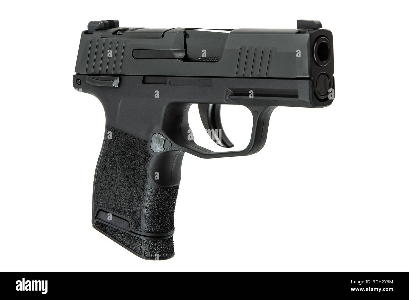 Black semi-automatic compact pistol with textured grip isolated on white. Stock Photo