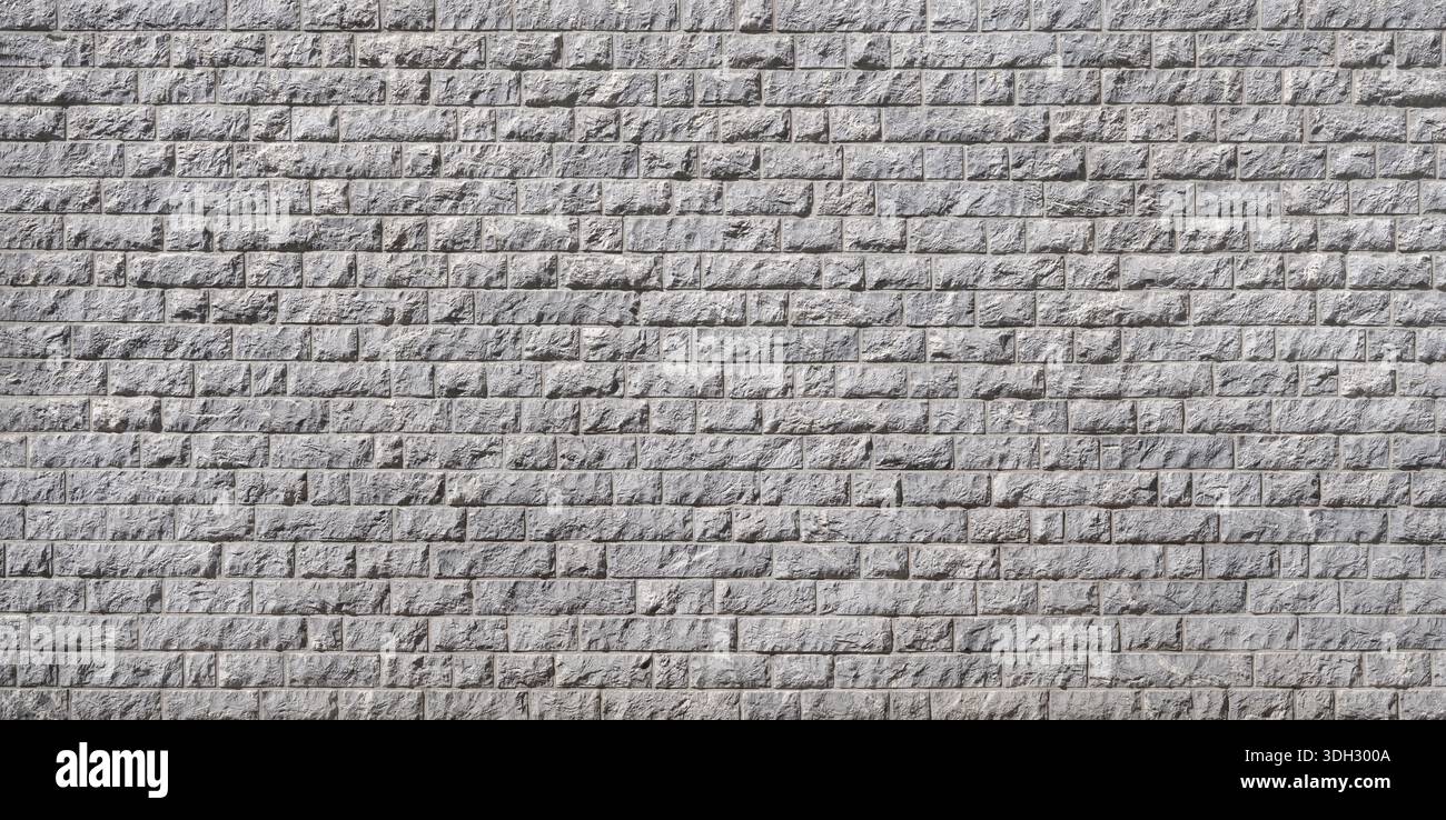 Cladding of a facade made of many rectangular gray stones Stock Photo