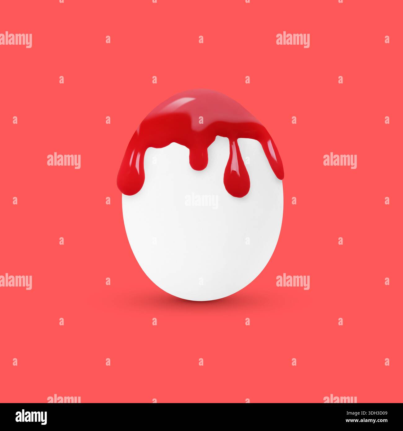 Red paint dripping down egg on coral background. Easter celebration Stock Photo