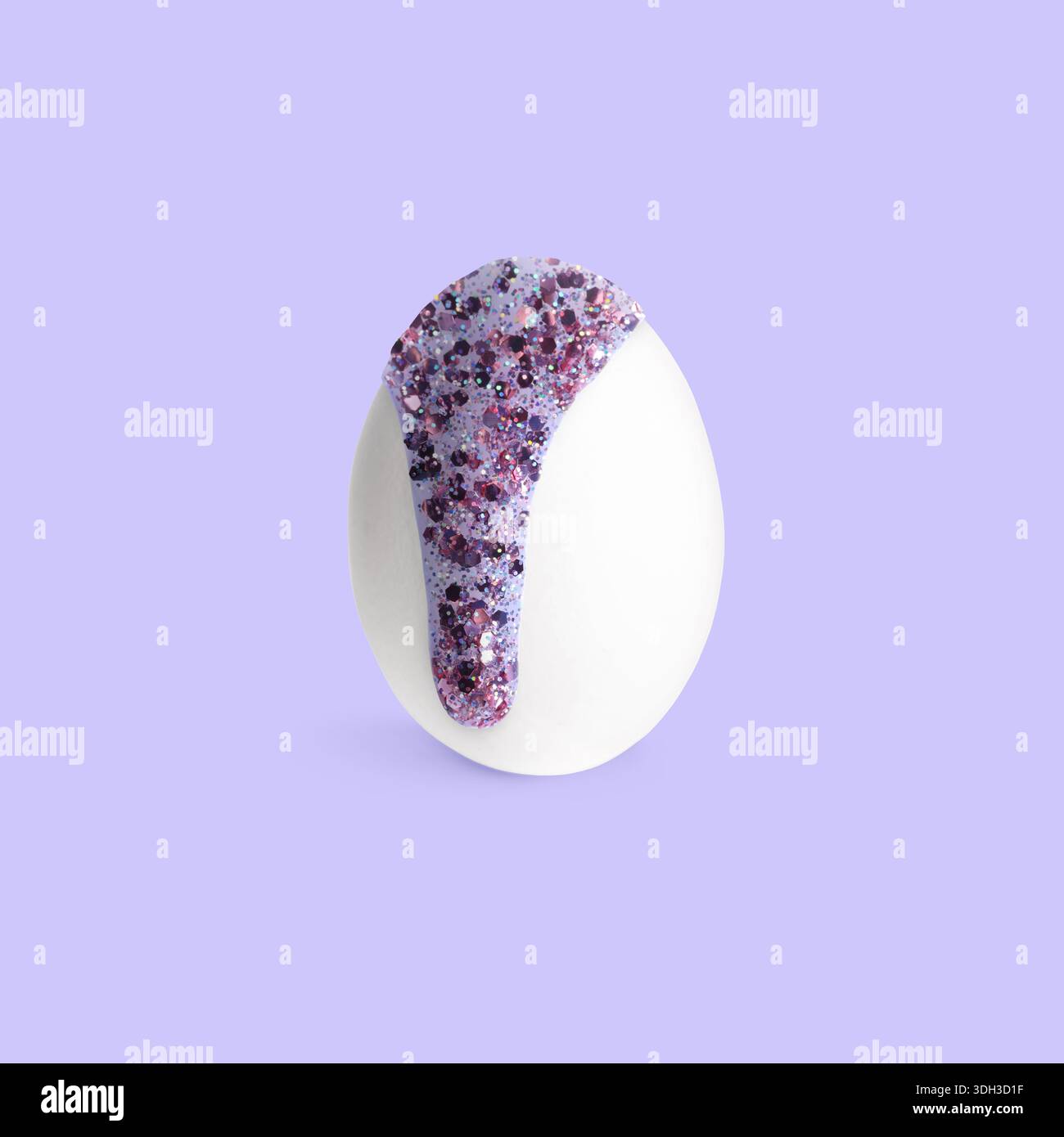 Paint with glitter dripping down egg on lavender background. Easter celebration Stock Photo