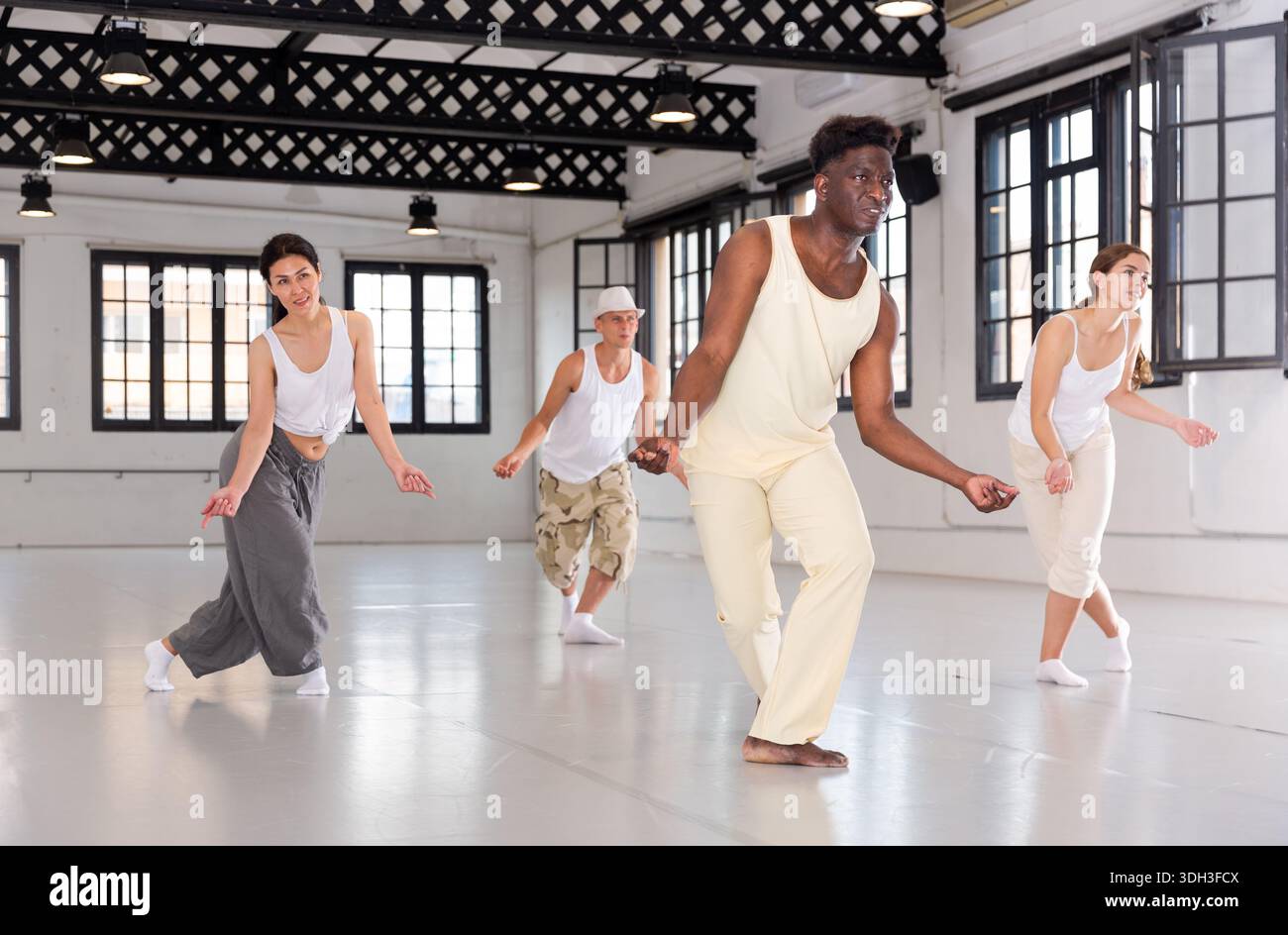 Four dancers exercising swing movements Stock Photo