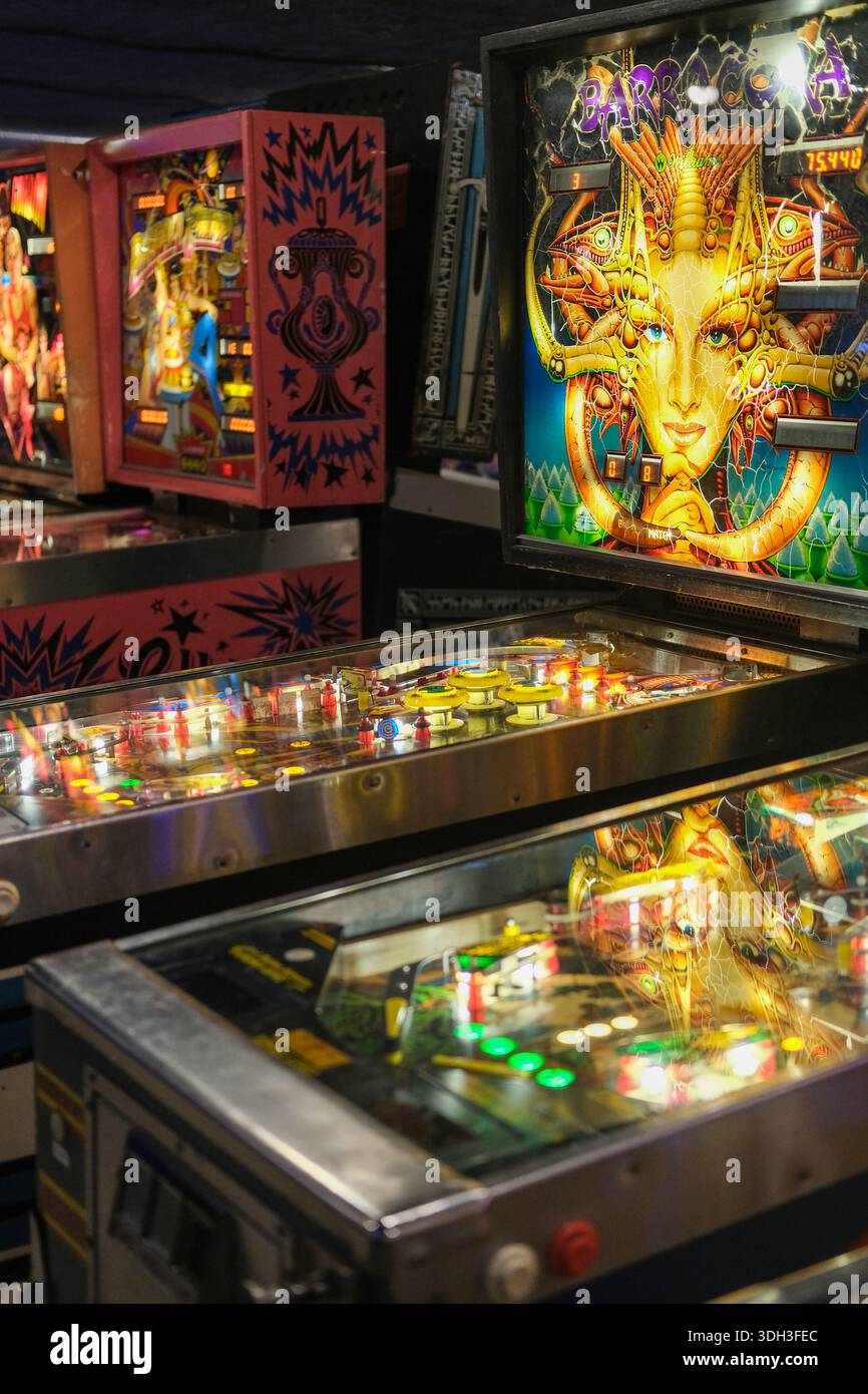 Pinball Machine Back Side Side-by-side view of two classic pinball cabinets showing colorful ...