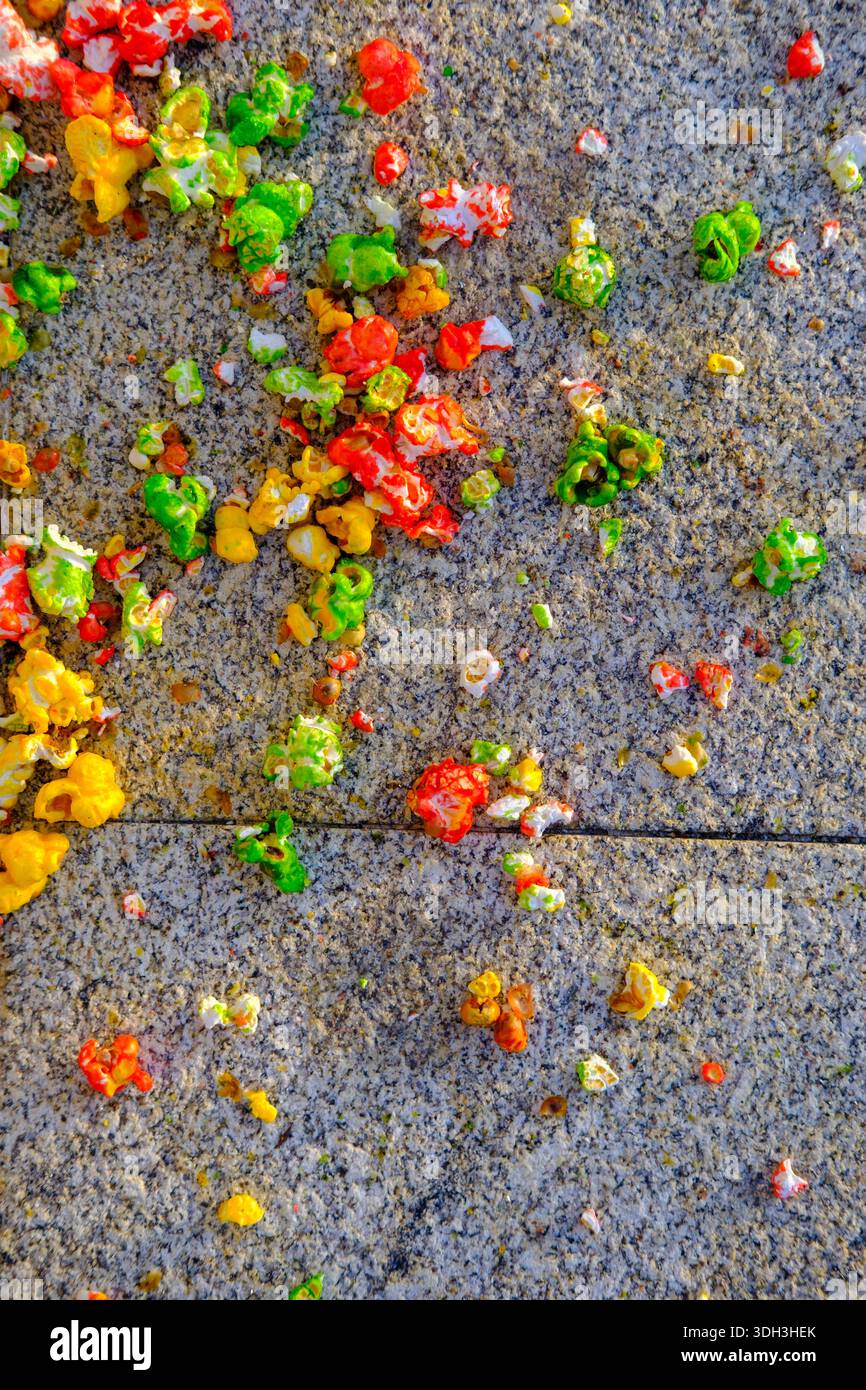Scattered colorful popcorn on a textured stone surface Stock Photo