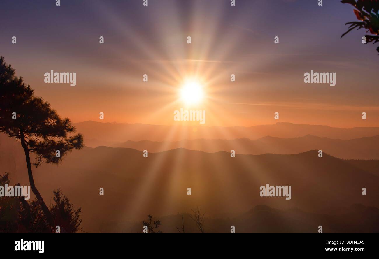 The sunset over mountain range and dramatic sky. Stock Photo