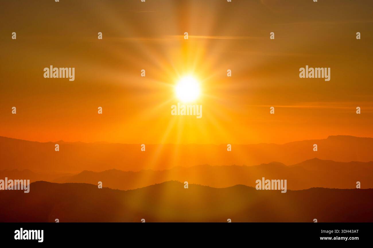 The sunset over mountain range and dramatic sky. Stock Photo