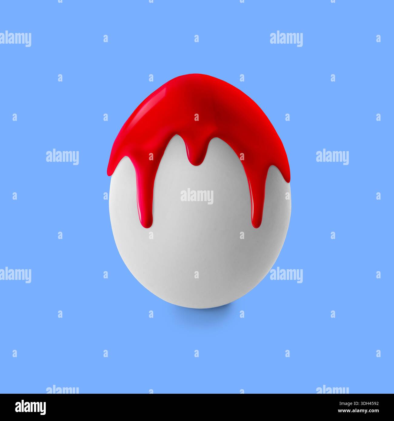 Red paint dripping down egg on pastel blue background. Easter celebration Stock Photo