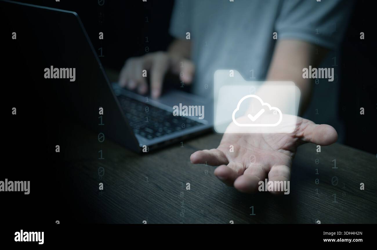 Hand offering cloud folder icon on laptop represents digital files, paperless office, file management, cloud storage technology to enhance document wo Stock Photo