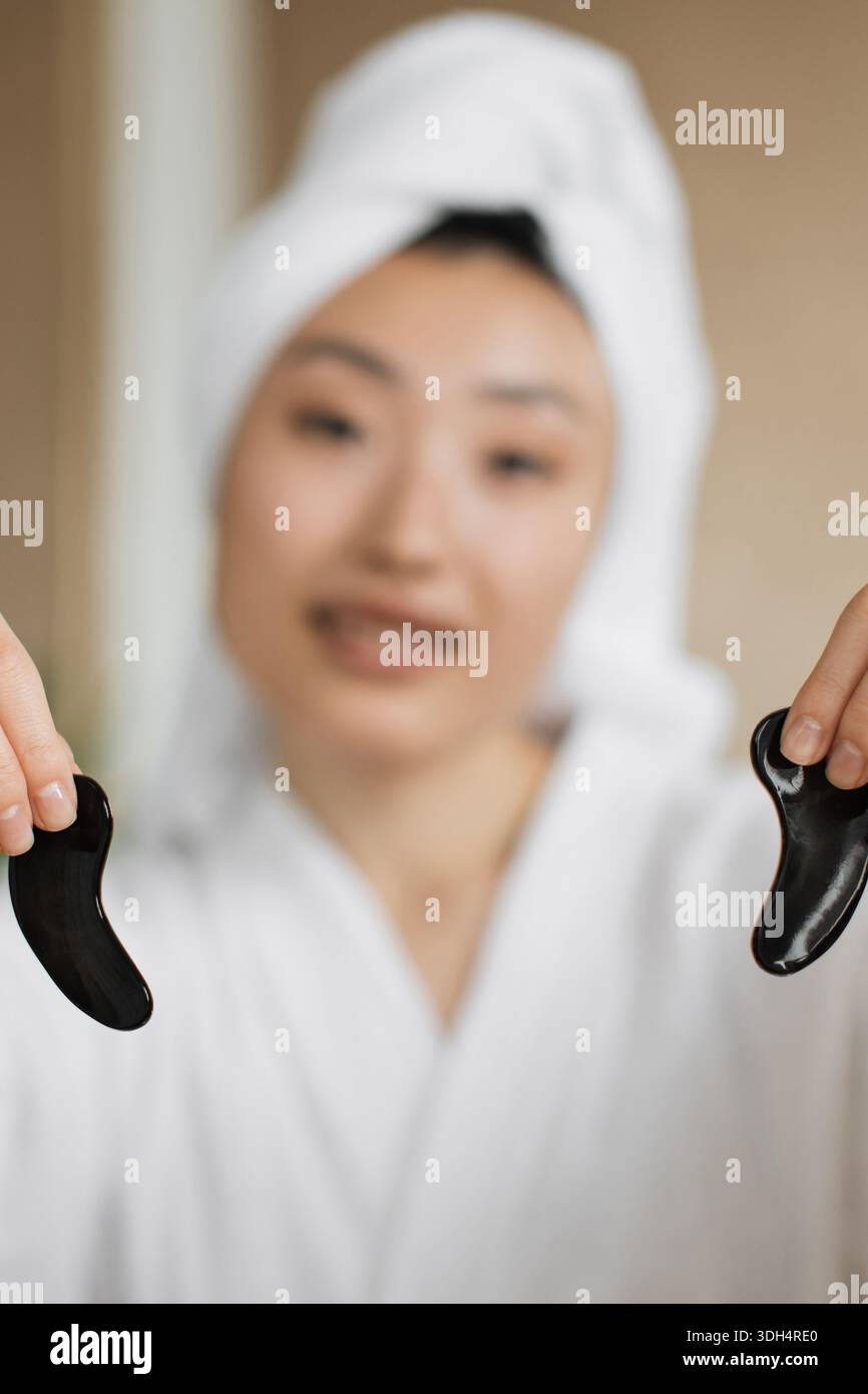 Woman Holding Gua Sha Tools Stock Photo