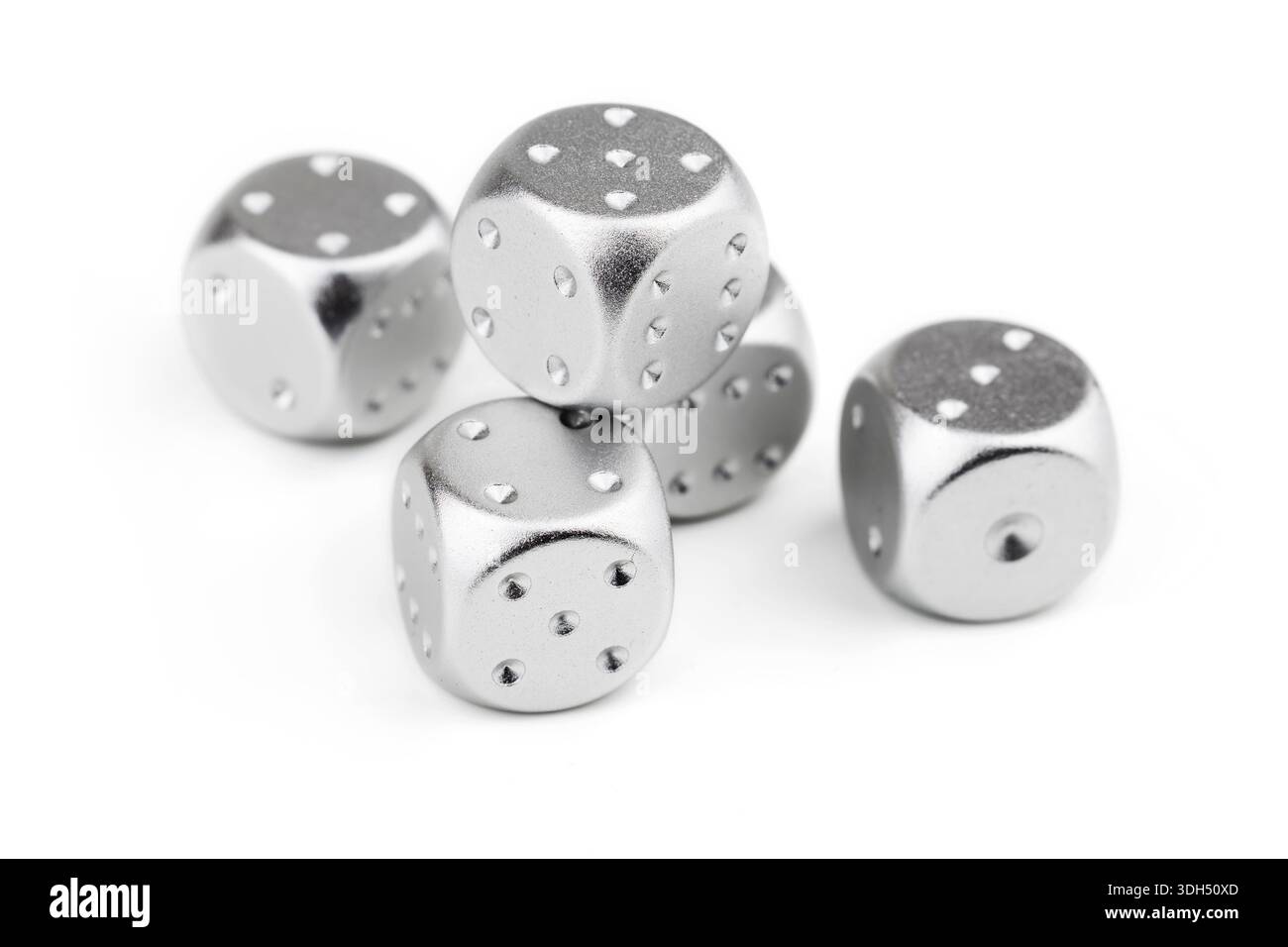five silver dice view from above on white background. Stock Photo
