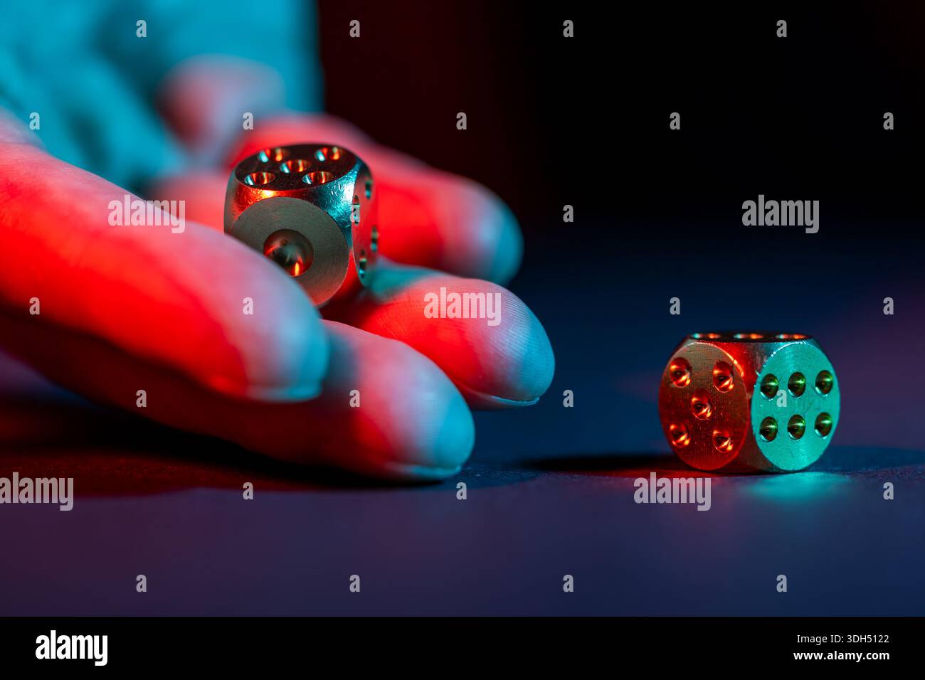 hand throws two dice on a black background, Stock Photo
