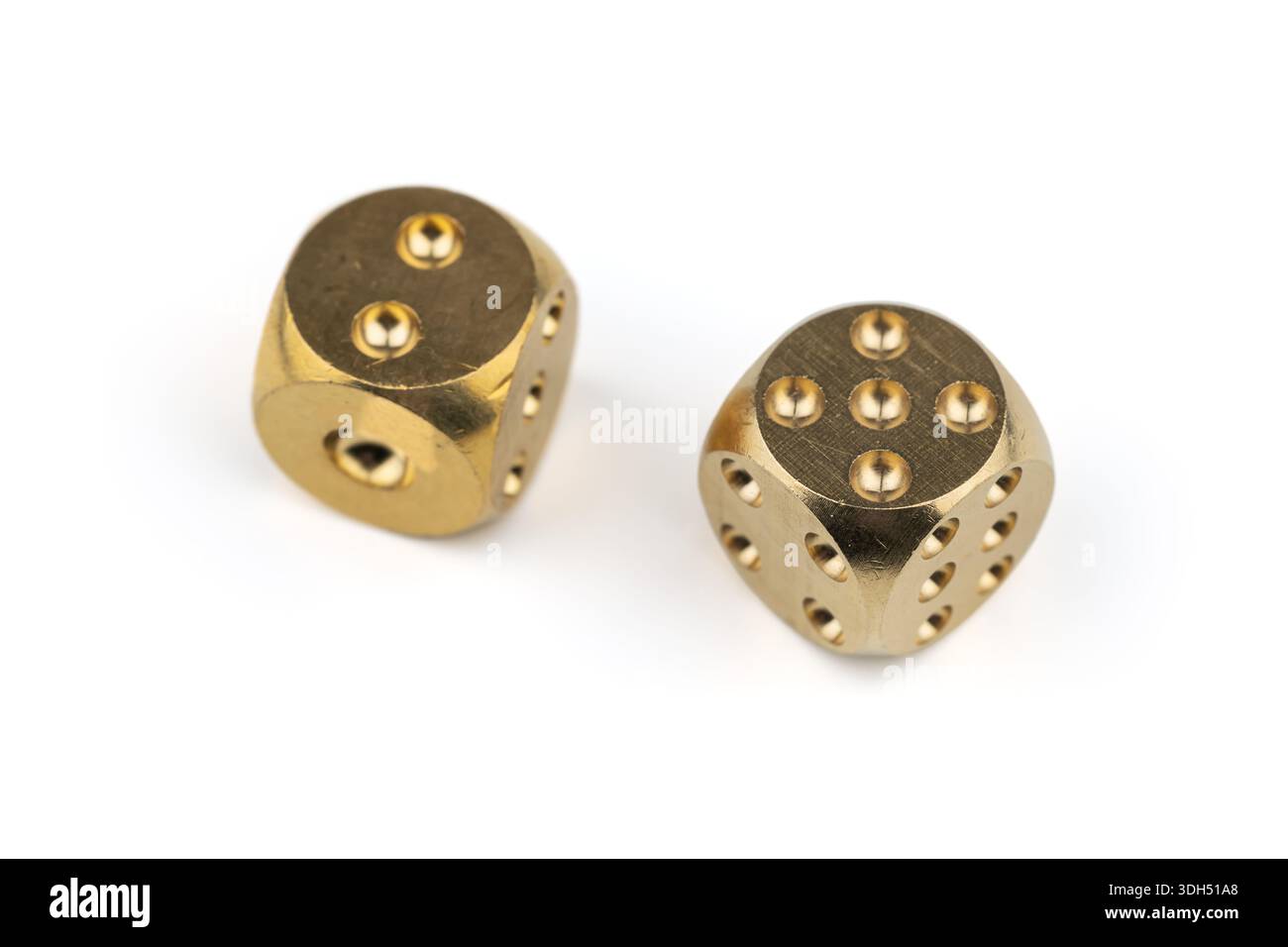 Two golden dice on white background. Stock Photo