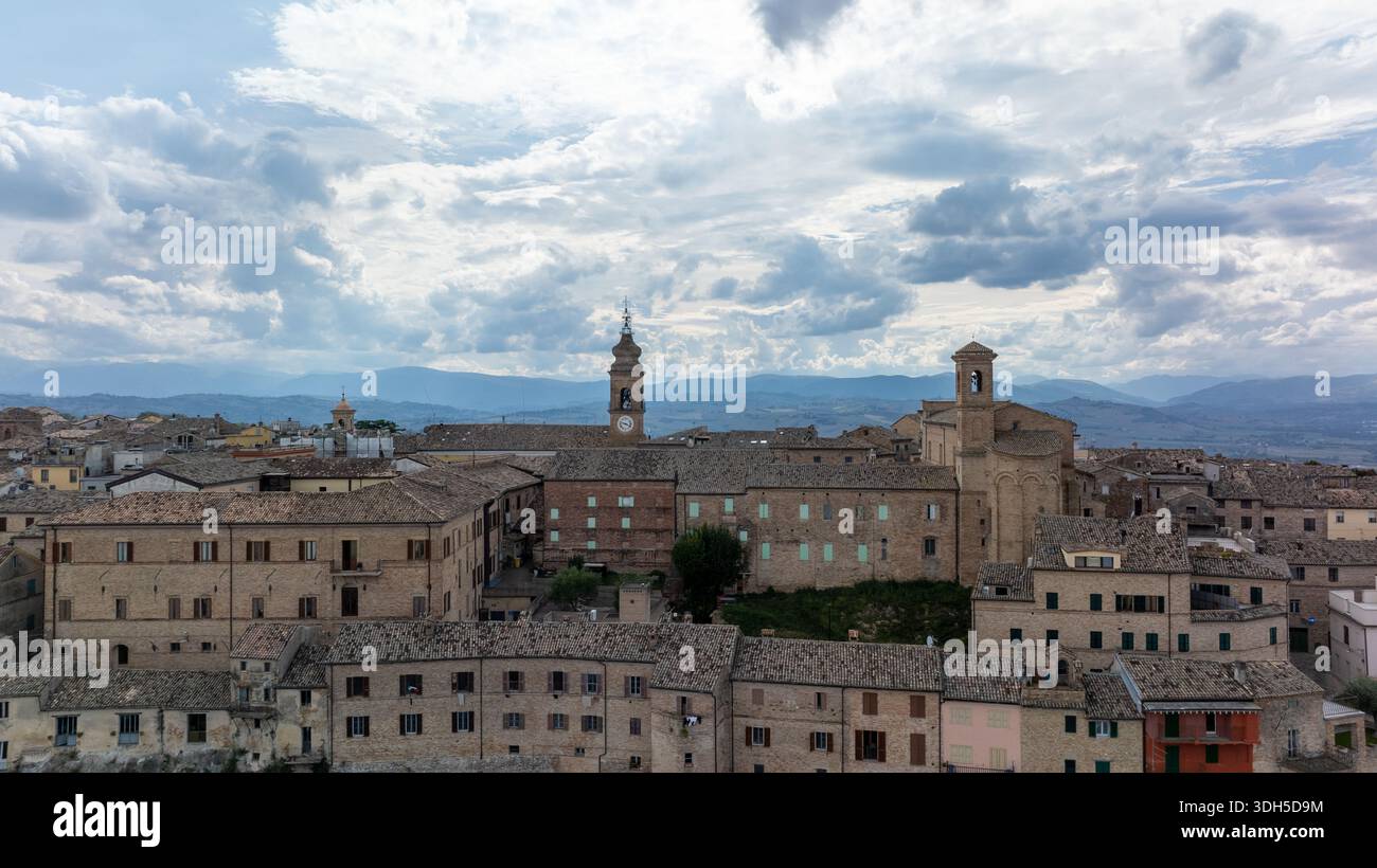 Drone view of an Italian historic city, showcasing ancient architecture and rooftops under a dramatic sky. Towering landmarks rise amidst the charming Stock Photo