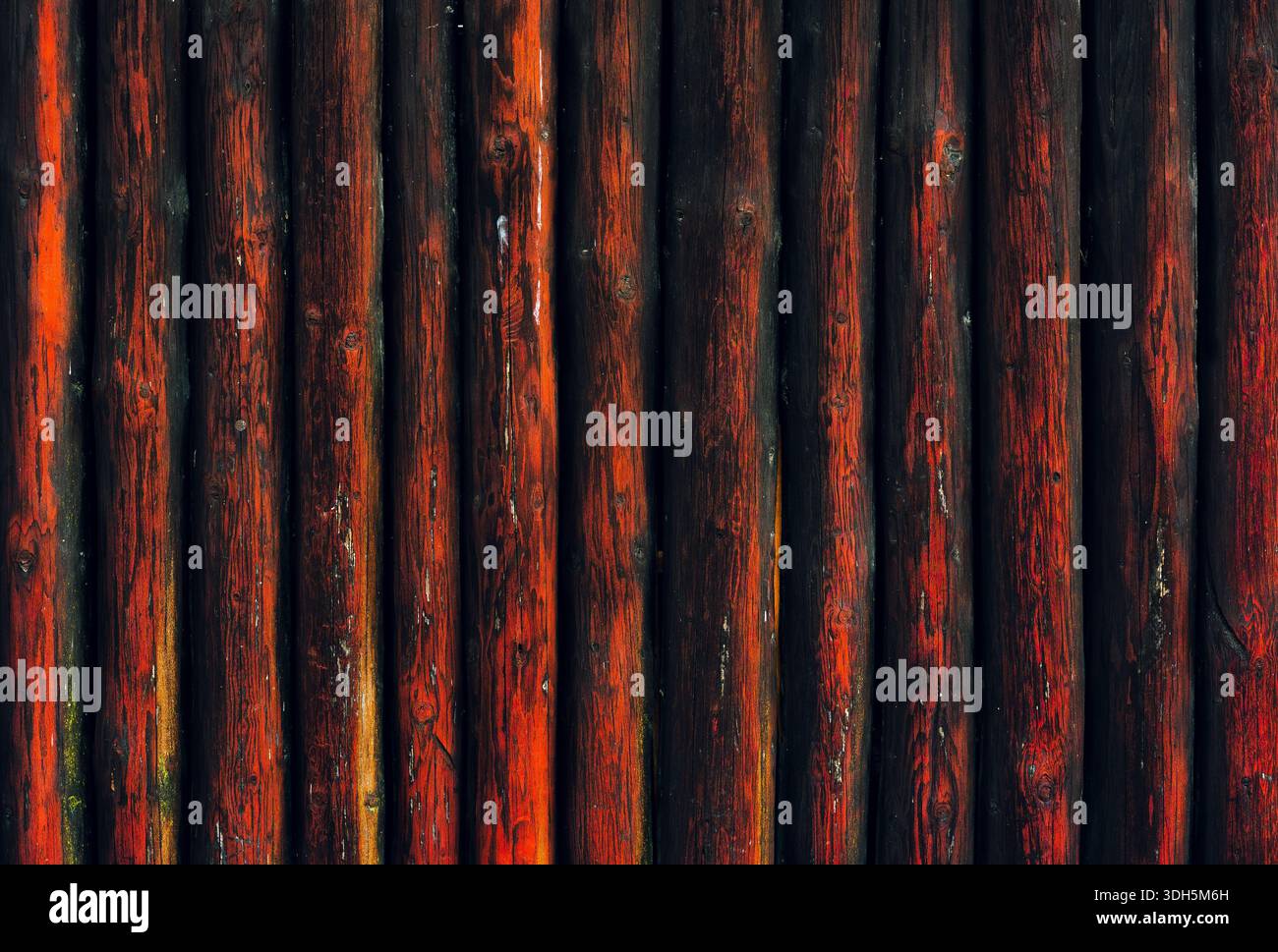 Vertical Wooden Logs with Dark Red Weathered Surface Texture Stock Photo