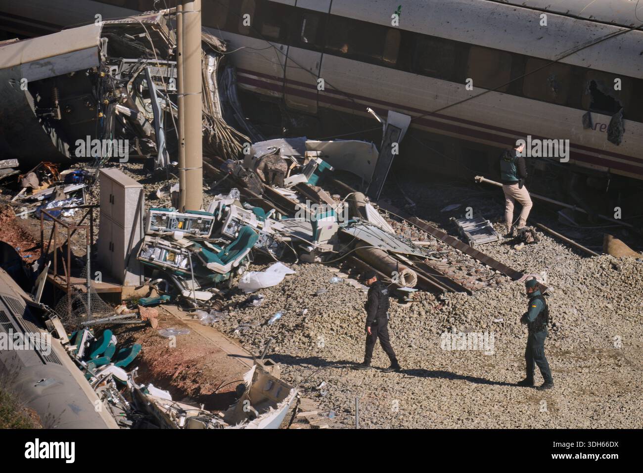 Guardia Civil officers collect evidence next to the wreckage of train ...