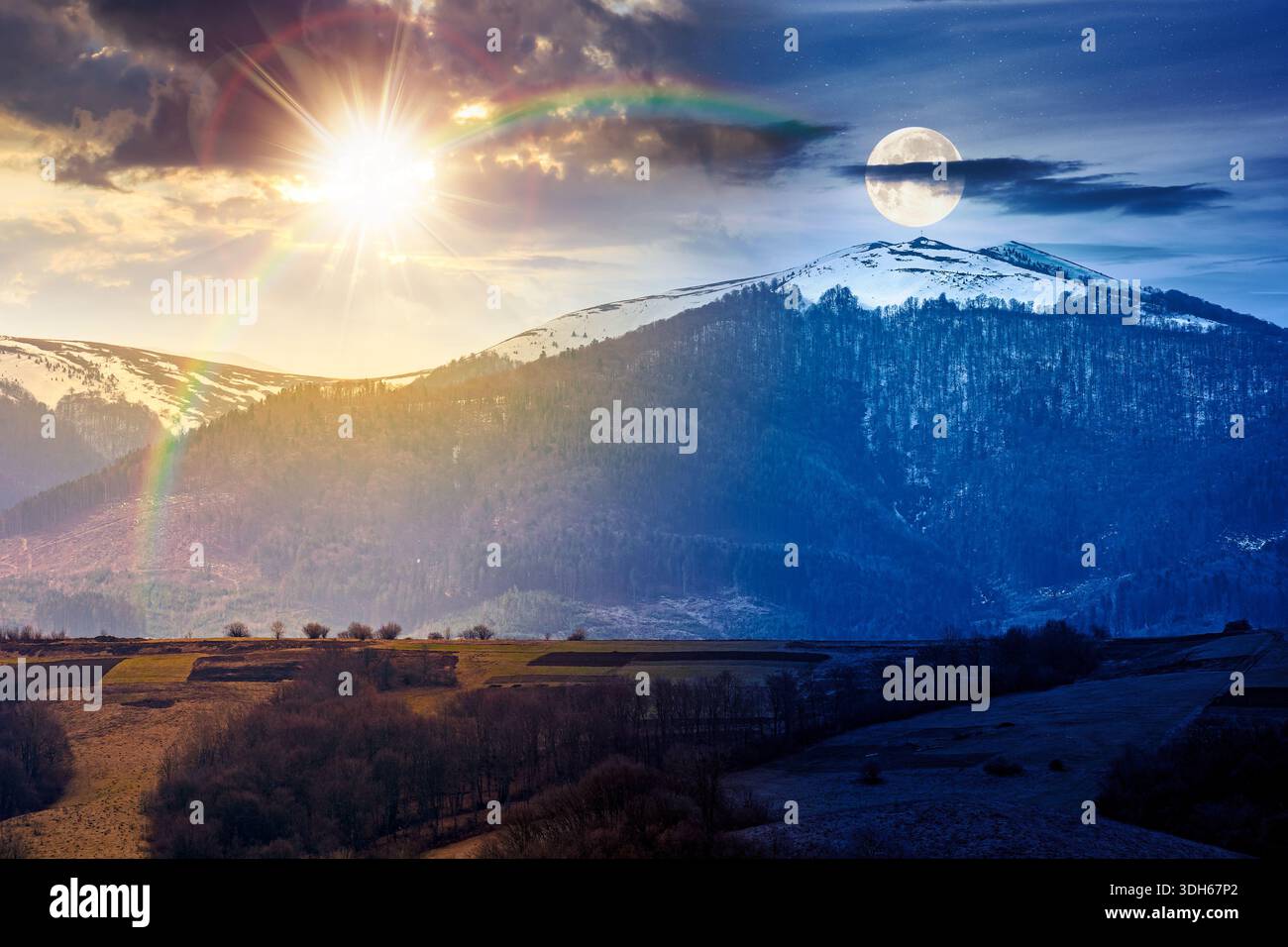mountains on spring equinox. day and night time change concept. view of countryside landscape with rolling hills and snow covered peak with sun and mo Stock Photo