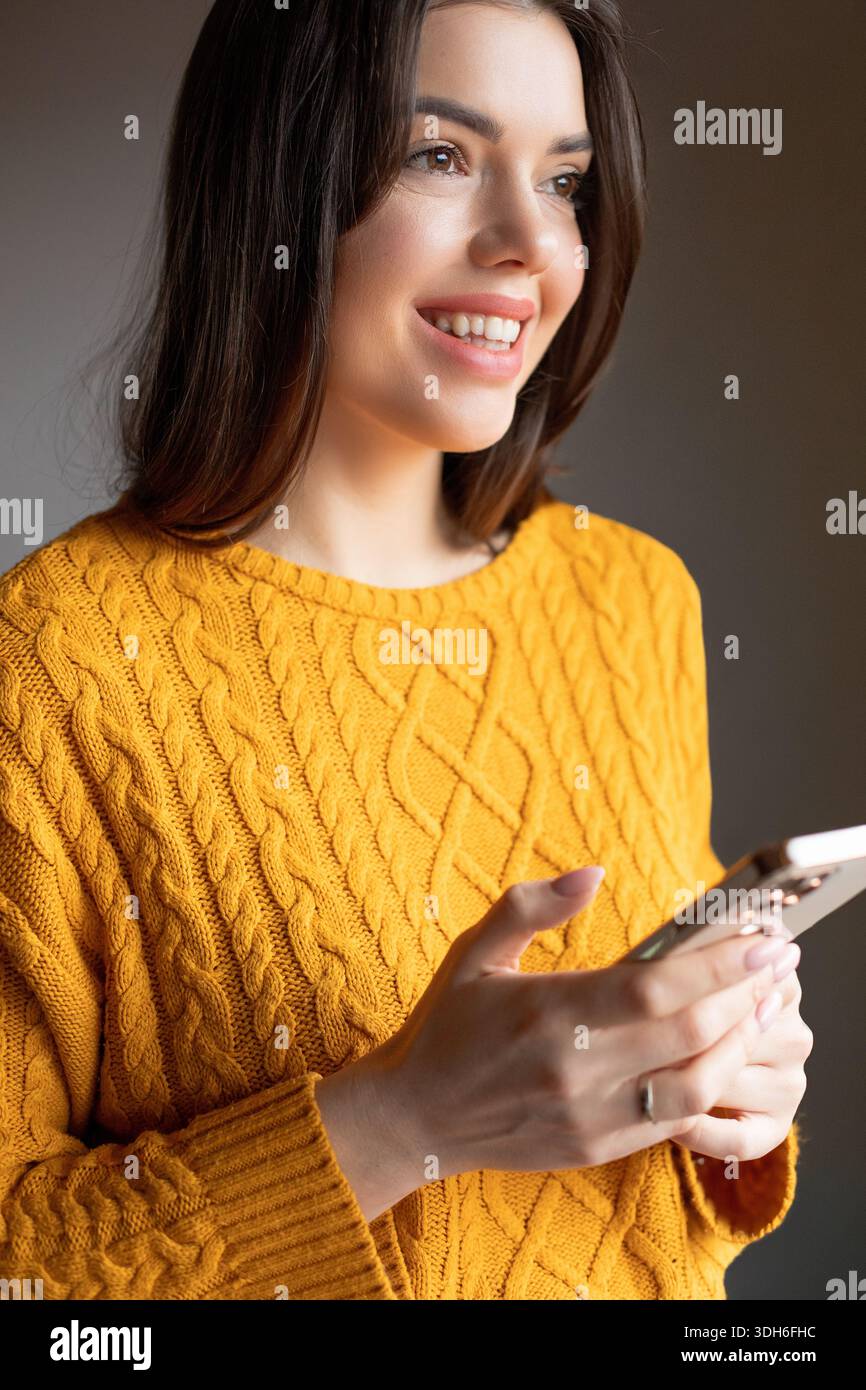 Woman in yellow sweater wearing hi-res stock photography and images - Alamy