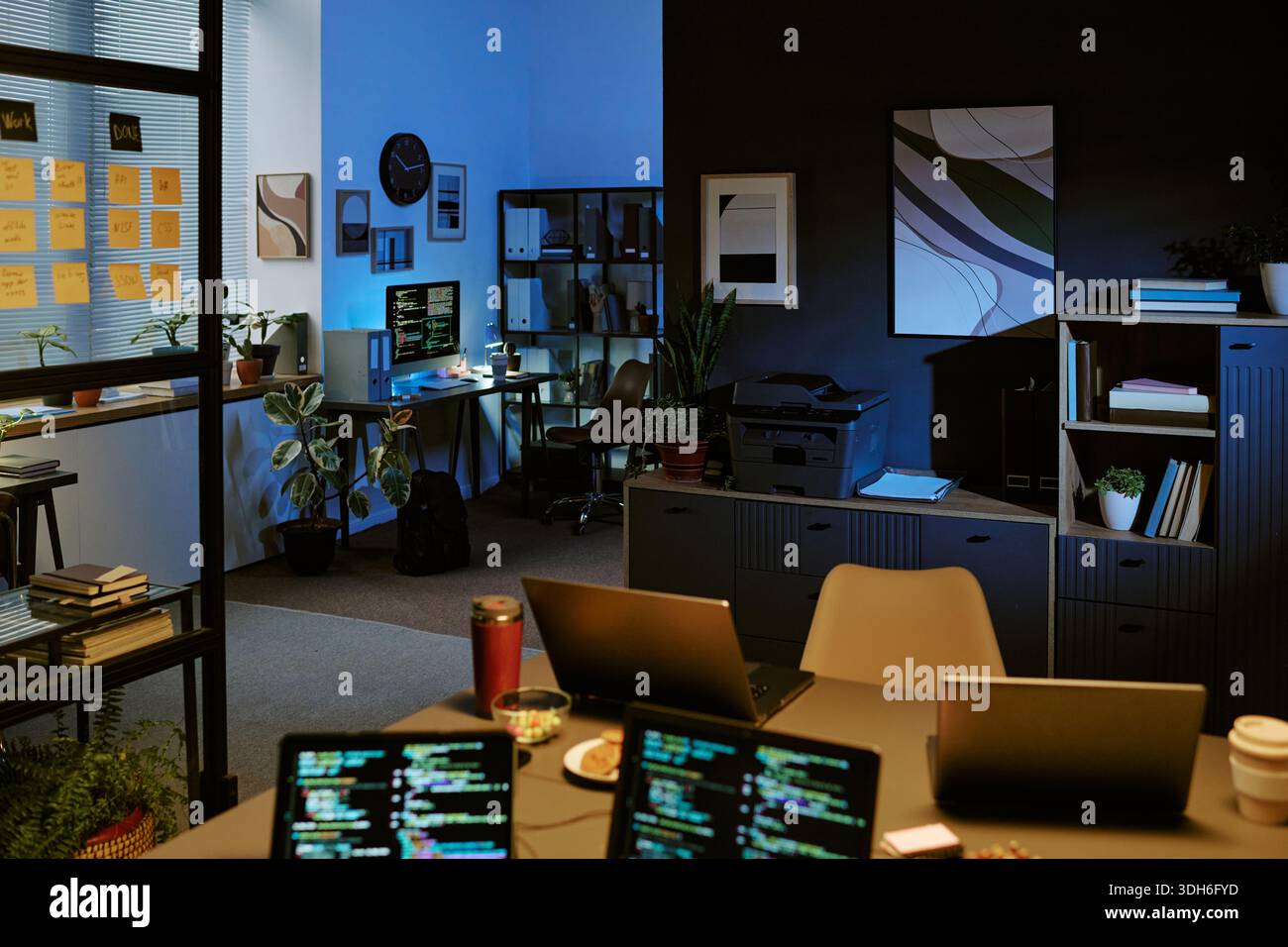Empty Modern Office Showing Computer Screens Displaying Programming Code Stock Photo