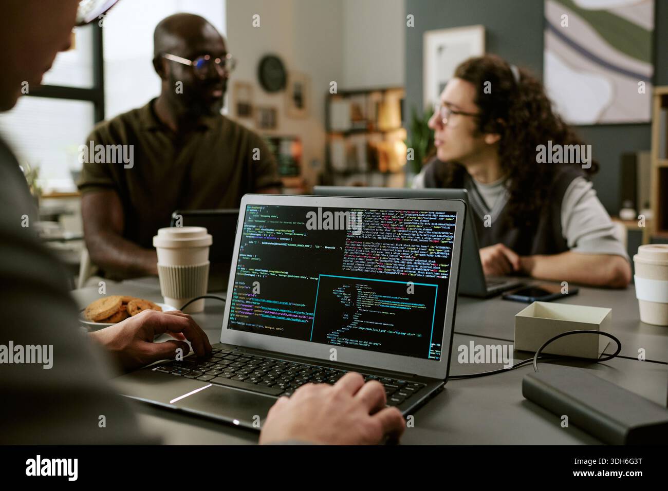 Young Adult Multiethnic Coworkers Collaborating on Software Development Project Stock Photo