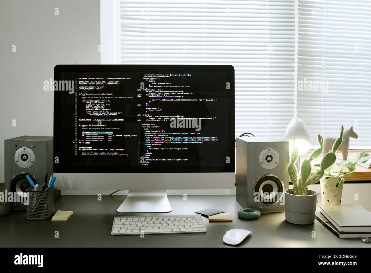 Modern Workspace Featuring Computer Monitor Displaying Programming Code Stock Photo