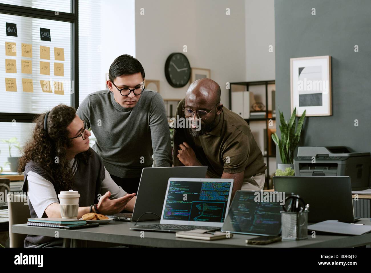 Young Multiethnic Team Discussing Software Development Strategies in Office Stock Photo
