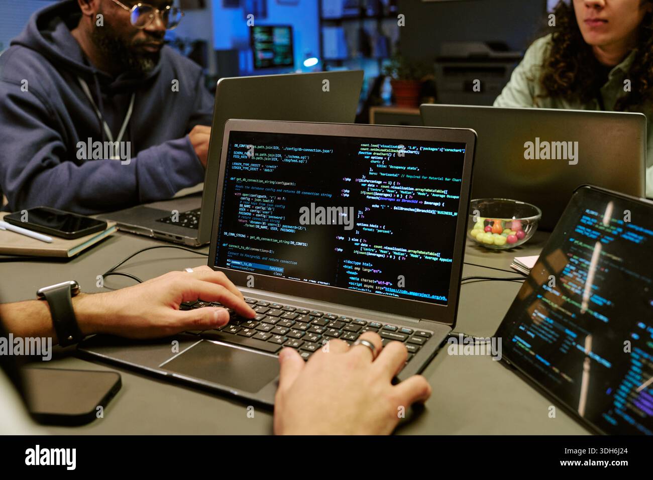 Young Adult Men Collaborating on Software Development Project Stock Photo