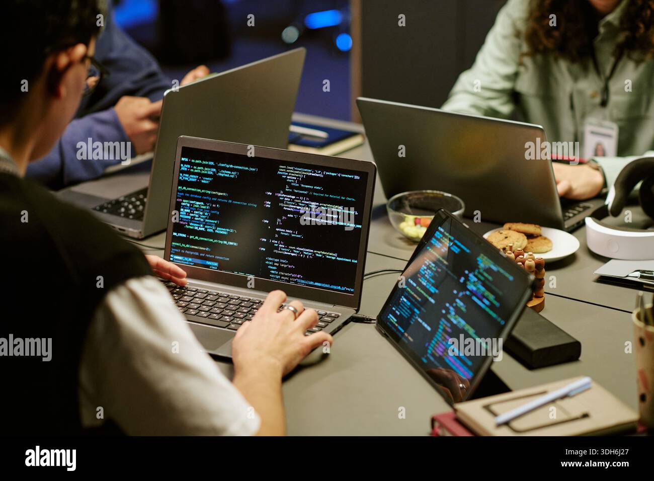 Young Adult Men and Women Collaborating on Software Development Project Indoors Stock Photo