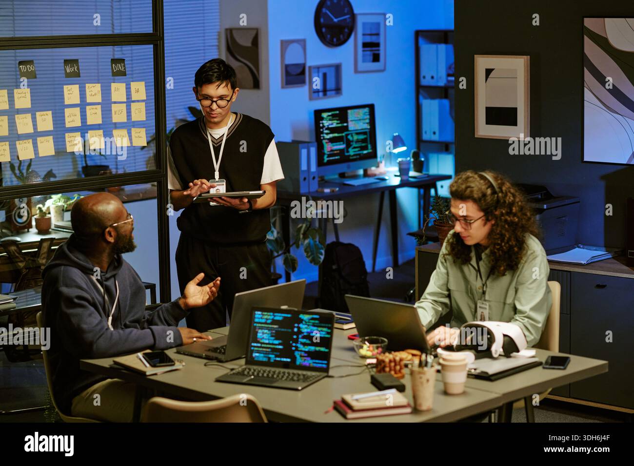 Multiethnic Young Adults Collaborating on Software Development Project in Office Stock Photo