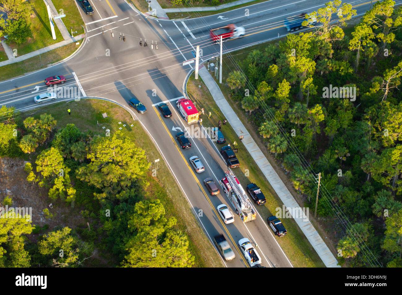 Car crash site with emergency services personnel and vehicles ...