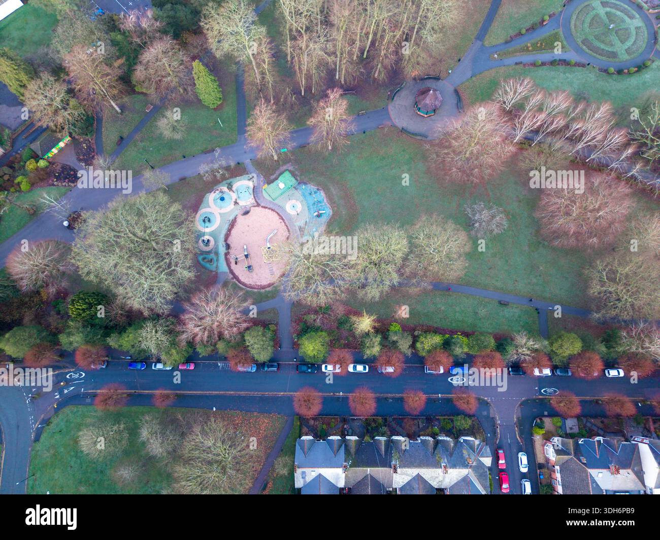 Aerial view of a park featuring winding paths, a playground with ...