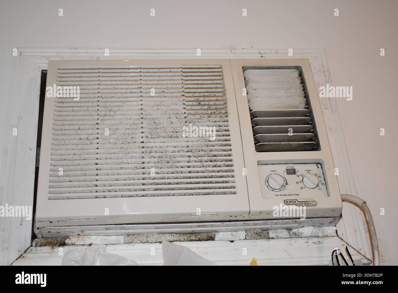 The old Window Air Conditioner on the wall Stock Photo