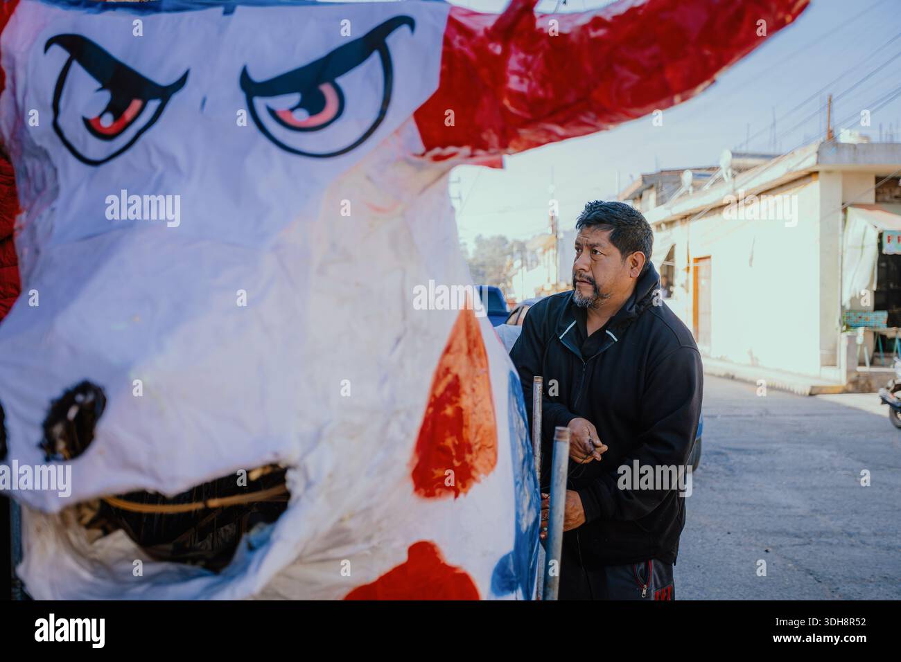 A Mexican man adjusts the wheeled structure of a monumental painted ...