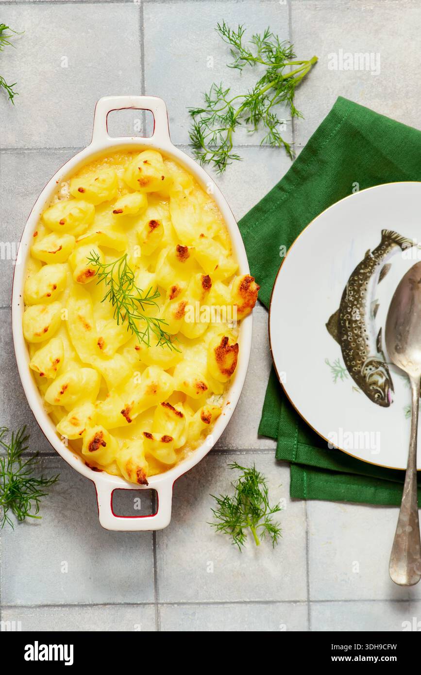 Shepherd's pie with salmon, green peas, mashed potatoes baked in a pan.top veiw.selective focus Stock Photo